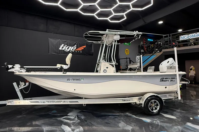 Slide: The Image of 2024 Carolina Skiff 21 LS boat on trailer in showroom with modern lighting. - 5
