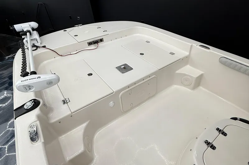 Slide: The Image of 2024 Carolina Skiff 21 LS boat deck with storage compartments and trolling motor. - 6