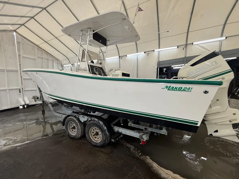 Slide: The Image of 1996 Mako 241 boat on trailer in covered storage area. - 2
