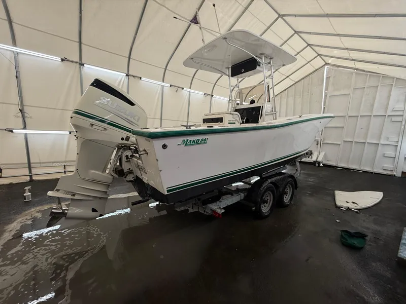 Slide: The Image of 1996 Mako 241 boat on trailer inside a large white tent. - 5