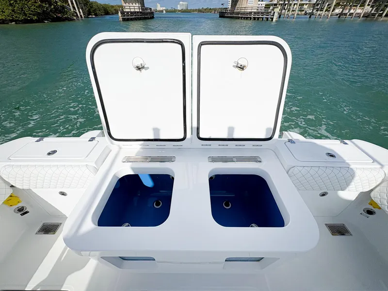 Slide: The Image of 2023 HCB 39 Speciale boat with open storage compartments on deck, overlooking water. - 11