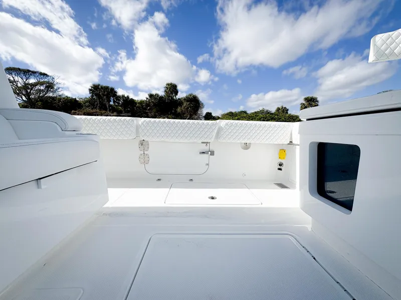 Slide: The Image of 2023 HCB 39 Speciale boat interior with white seating and clear blue sky. - 13