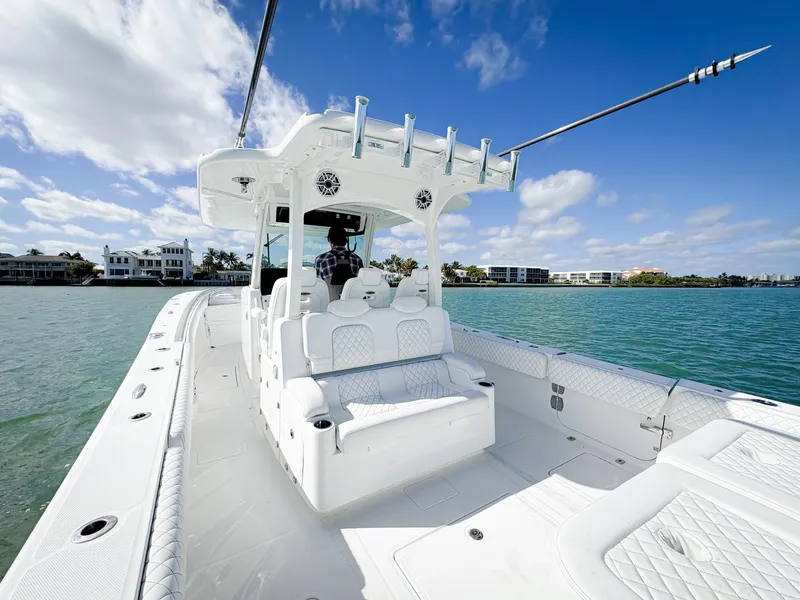 Slide: The Image of 2023 HCB 39 Speciale boat on water, clear sky, luxury seating, coastal background. - 14