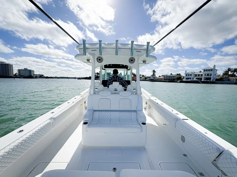 Slide: The Image of 2023 HCB 39 Speciale boat on water, clear sky, luxury seating, coastal view. - 15