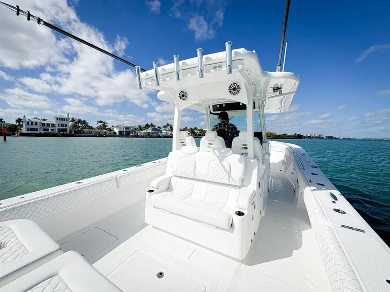 Slide: The Image of 2023 HCB 39 Speciale boat on water, featuring sleek white design and spacious seating. - 16