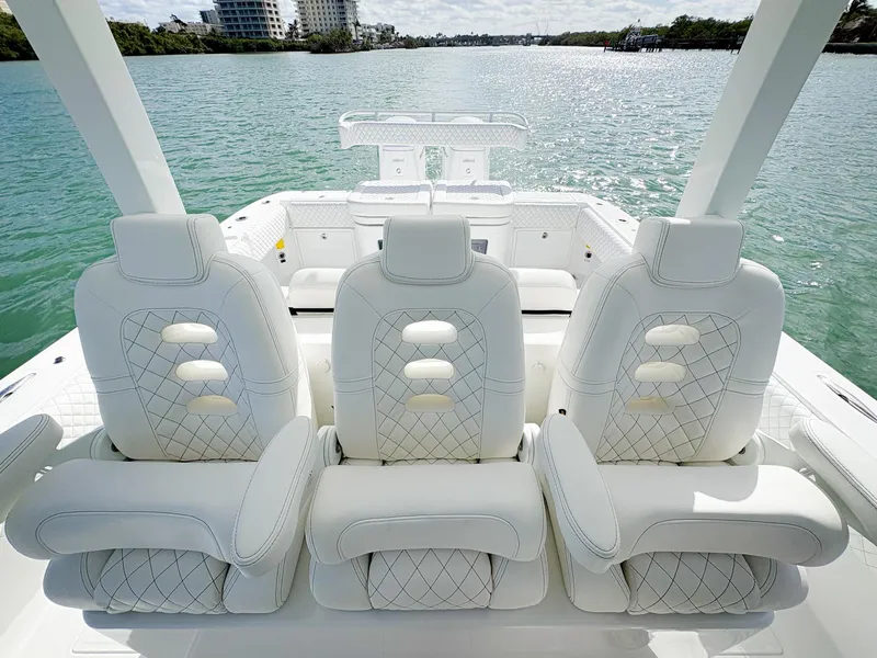 Slide: The Image of 2023 HCB 39 Speciale luxury boat with white leather seating on a sunny day. - 21