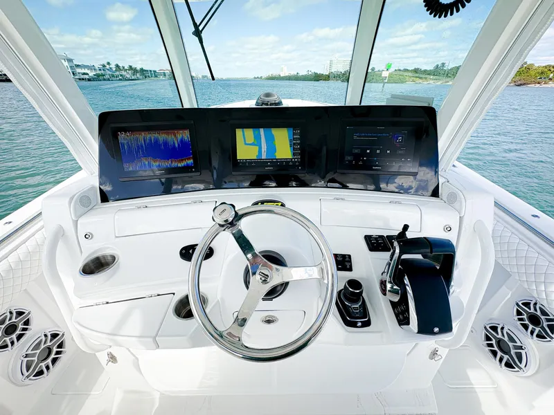 Slide: The Image of 2023 HCB 39 Speciale boat helm with advanced navigation displays and controls. - 23