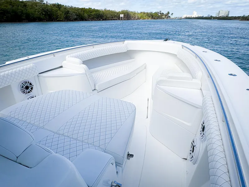 Slide: The Image of 2023 HCB 39 Speciale boat interior with luxurious white seating on a serene waterway. - 26