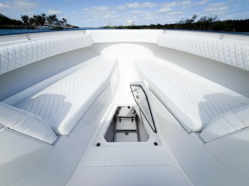 Slide: The Image of 2023 HCB 39 Speciale boat interior with white quilted seating and storage compartment. - 27