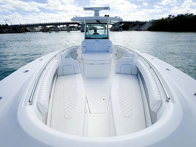 Slide: The Image of 2023 HCB 39 Speciale boat with luxurious seating on a calm waterway. - 28
