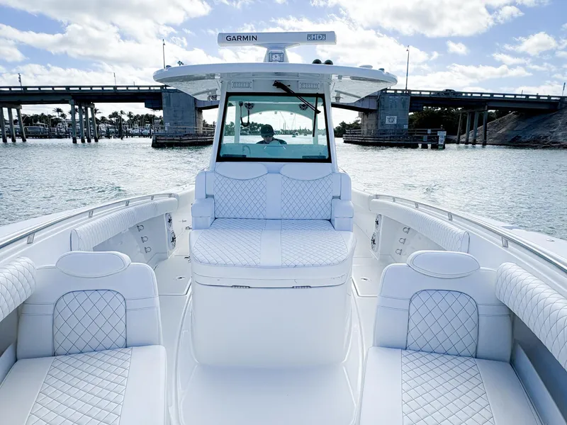 Slide: The Image of 2023 HCB 39 Speciale boat with luxurious seating, cruising under a bridge on a sunny day. - 29