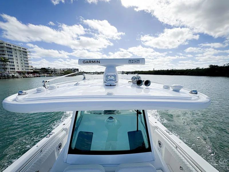 Slide: The Image of 2023 HCB 39 Speciale boat on water, featuring Garmin equipment under a clear blue sky. - 35