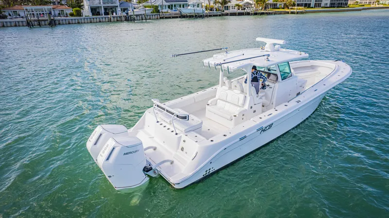 Slide: The Image of 2023 HCB 39 Speciale boat on calm water, featuring twin outboard engines. - 4