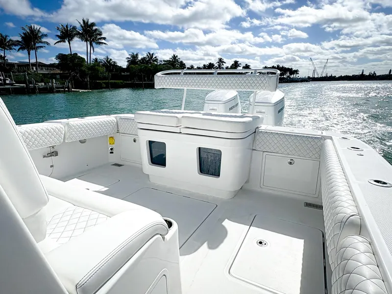 Slide: The Image of 2023 HCB 39 Speciale boat on water, featuring luxurious white seating and clear skies. - 8