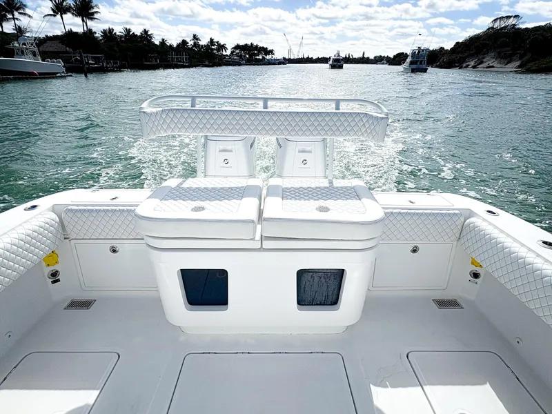 Slide: The Image of 2023 HCB 39 Speciale boat on water, featuring spacious deck and seating. - 9