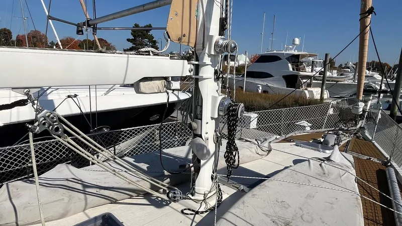 Slide: The Image of Sailboat deck of 1996 Amel Super Maramu-53, featuring rigging and marina background. - 10