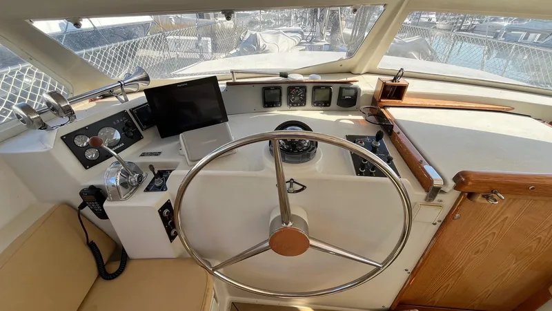 Slide: The Image of 1996 Amel Super Maramu-53 yacht cockpit with steering wheel and navigation instruments. - 13