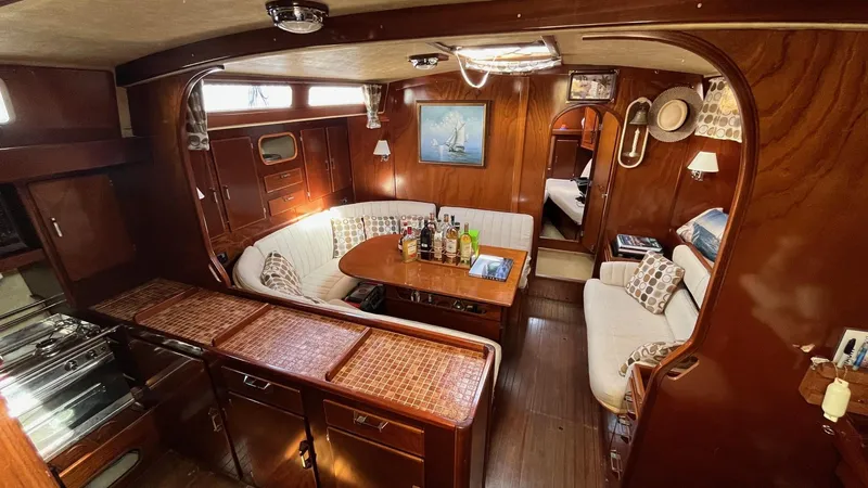 Slide: The Image of Interior of 1996 Amel Super Maramu-53 yacht with cozy seating and wooden finishes. - 21