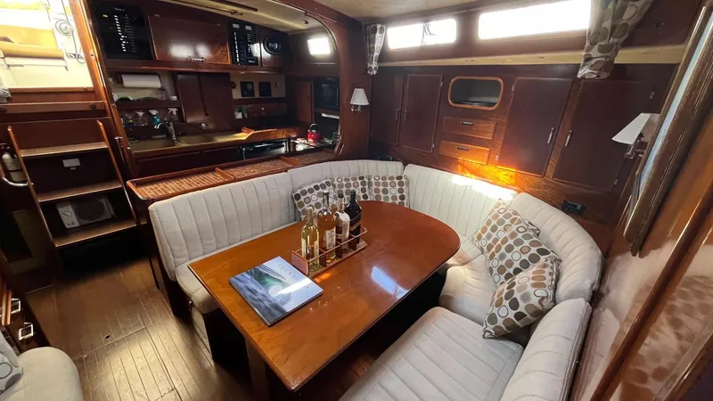 Slide: The Image of Luxurious interior of 1996 Amel Super Maramu-53 yacht with elegant seating and dining area. - 22