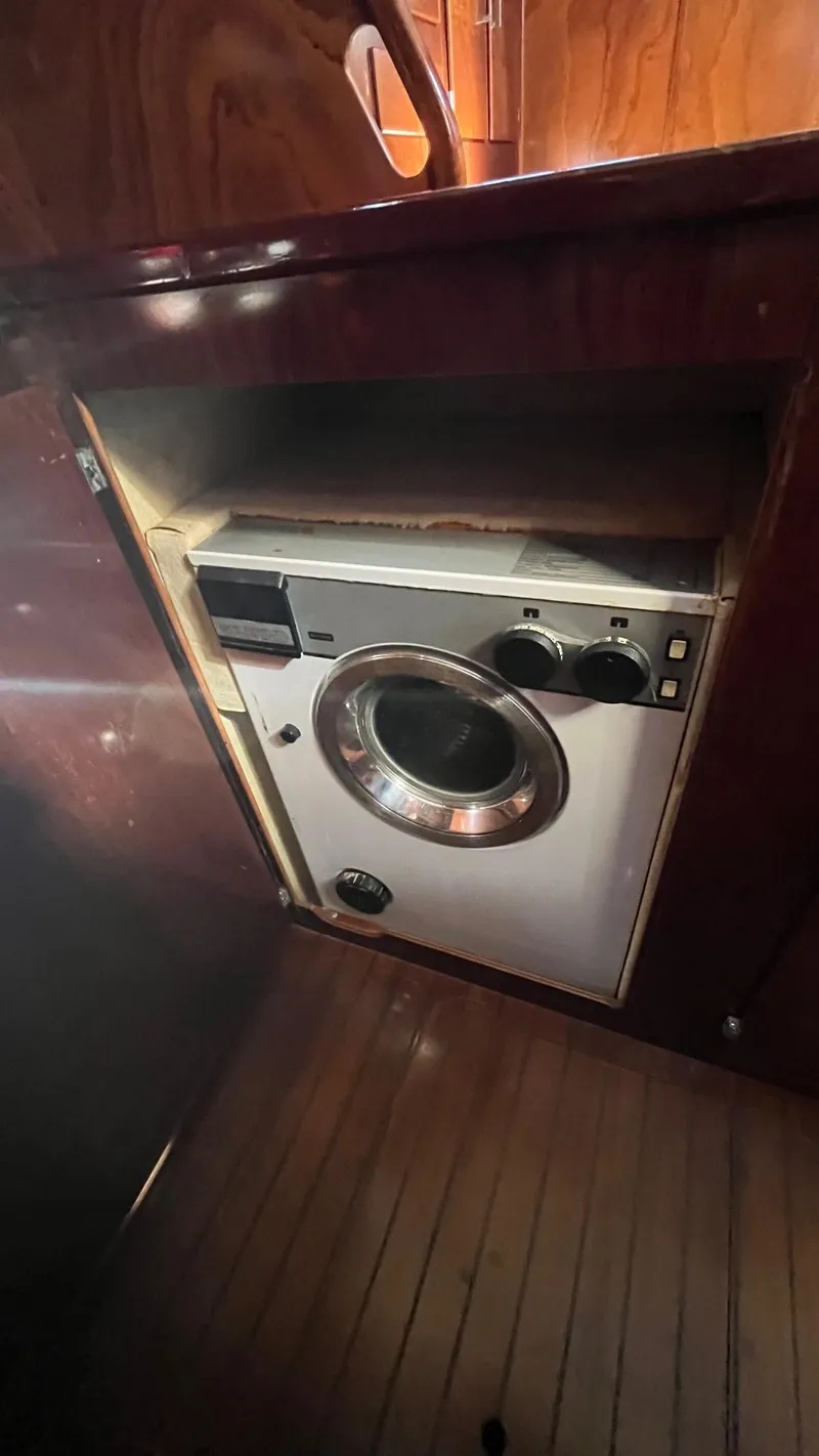 Slide: The Image of Washing machine inside 1996 Amel Super Maramu-53 yacht, wooden interior. - 25