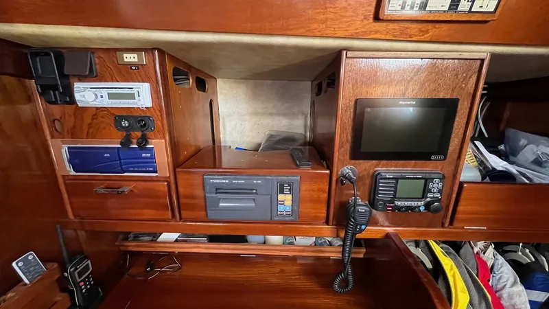 Slide: The Image of Navigation equipment on a 1996 Amel Super Maramu-53 yacht, featuring radio and control panels. - 29