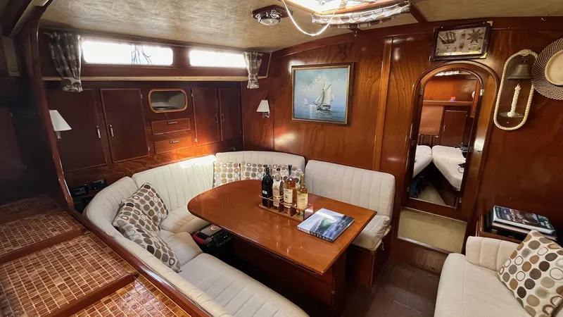 Slide: The Image of Luxurious interior of 1996 Amel Super Maramu-53 yacht with elegant wood finish and cozy seating. - 30