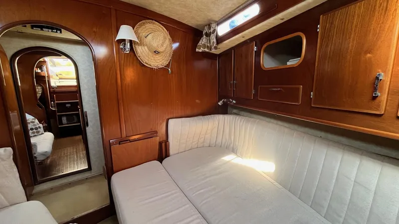 Slide: The Image of Interior of 1996 Amel Super Maramu-53 yacht with wooden paneling and cozy seating area. - 32