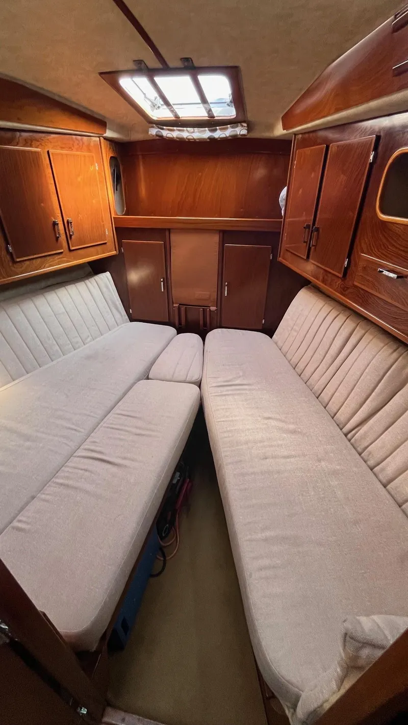 Slide: The Image of Interior of 1996 Amel Super Maramu-53 sailboat with cozy seating and wooden cabinetry. - 33