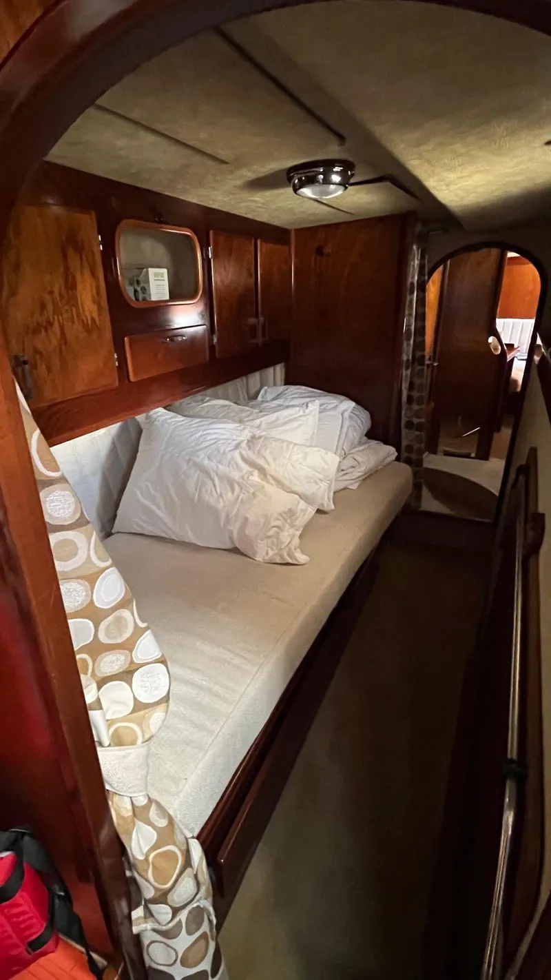 Slide: The Image of Cozy cabin interior of 1996 Amel Super Maramu-53 sailboat with wooden finish and bedding. - 35