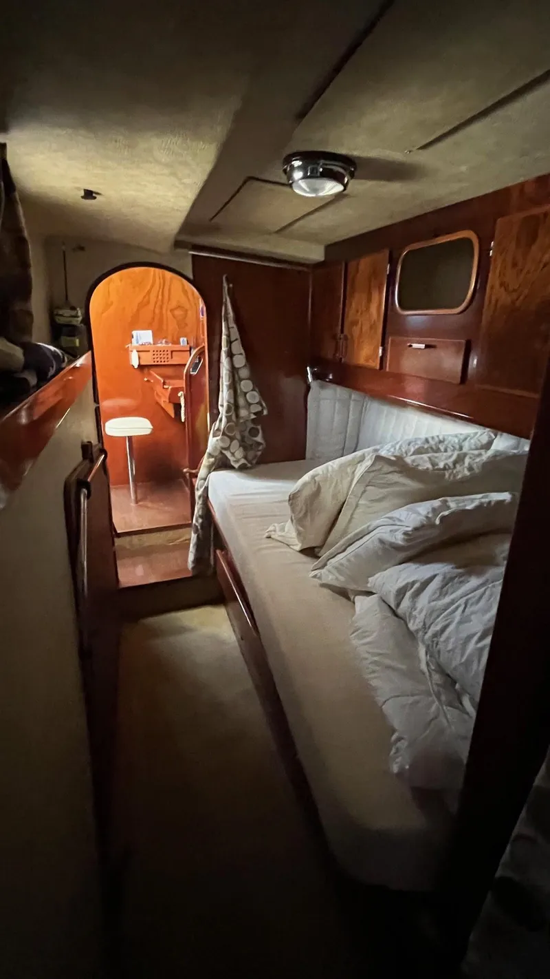 Slide: The Image of Cozy cabin interior of 1996 Amel Super Maramu-53 sailboat with wooden finish and bedding. - 37