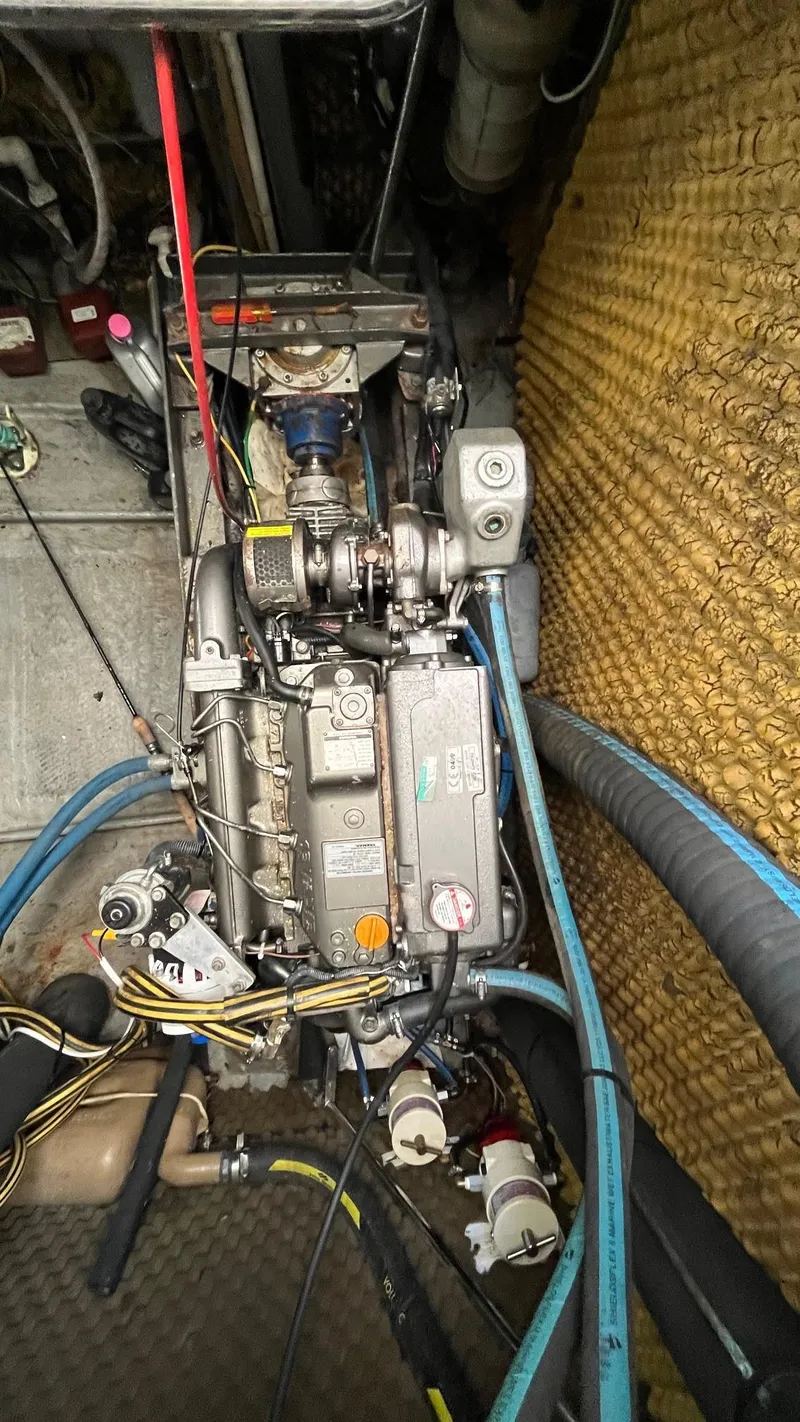 Slide: The Image of Engine compartment of a 1996 Amel Super Maramu-53 sailboat, showcasing mechanical components and wiring. - 47