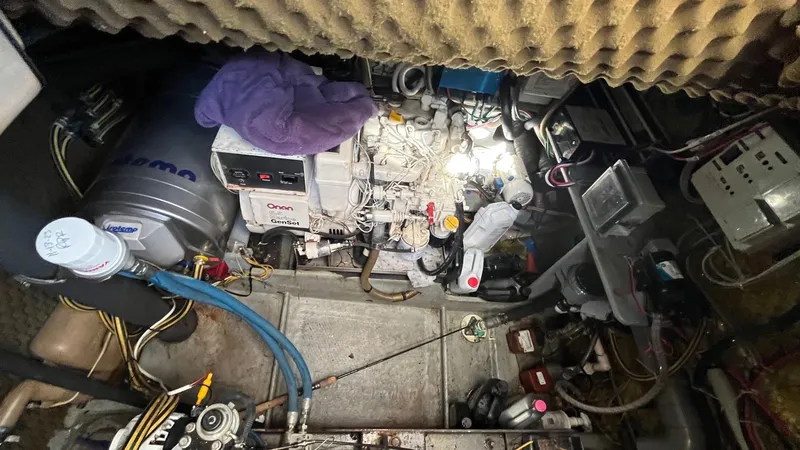 Slide: The Image of Engine room of a 1996 Amel Super Maramu-53 sailboat, featuring various mechanical components. - 48
