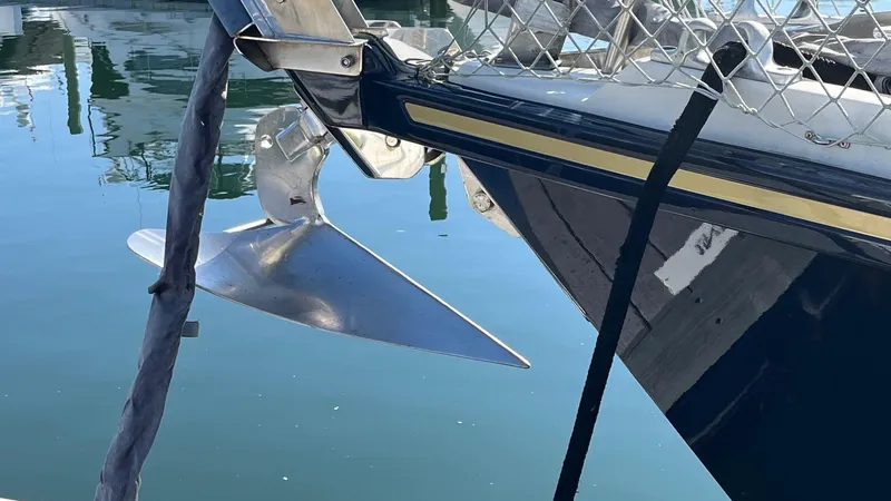 Slide: The Image of Bow of 1996 Amel Super Maramu-53 sailboat with anchor, docked in calm water. - 5