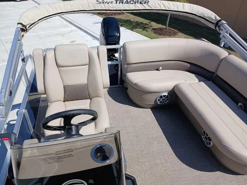 Slide: The Image of 2025 Sun Tracker Bass Buggy 16 XL Select pontoon boat with beige seating and steering console. - 5