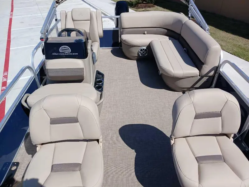 Slide: The Image of 2025 Sun Tracker Bass Buggy 16 XL Select pontoon boat interior with beige seating. - 6