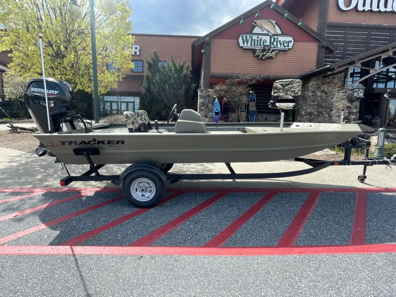 Slide: The Image of 2025 Tracker Grizzly 1754 SC boat on trailer outside White River Fly Shop. - 3