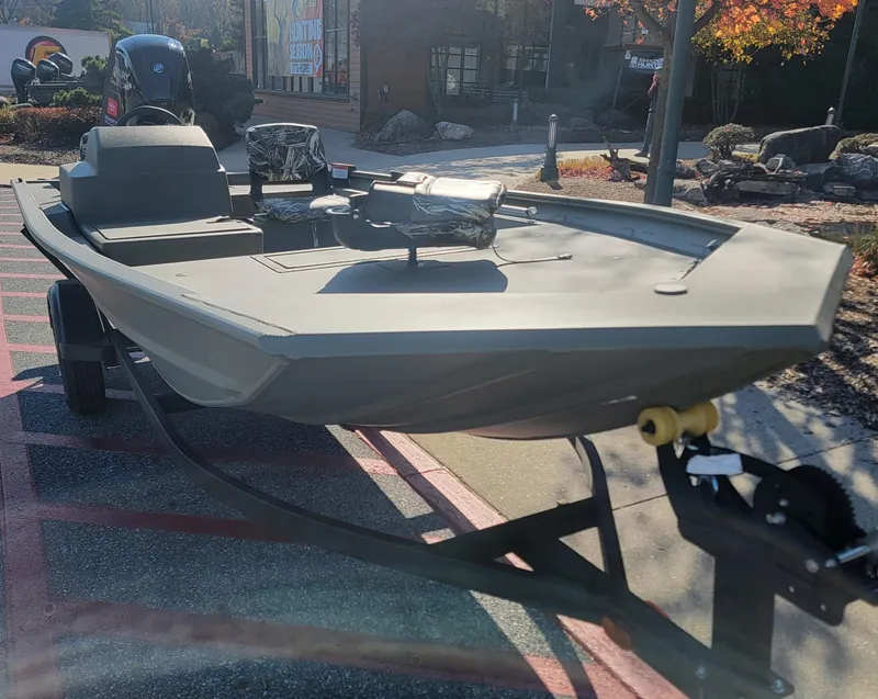 Slide: The Image of 2025 Tracker Grizzly 1754 SC boat on trailer, parked outdoors in sunlight. - 5