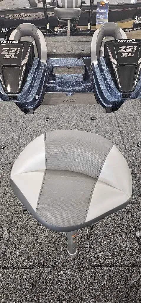 Slide: The Image of 2025 Nitro Z21 XL Pro boat interior with gray carpeted deck and seating. - 3