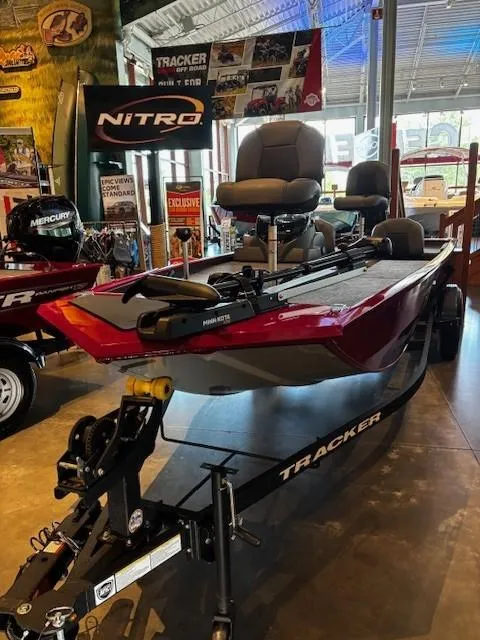 Slide: The Image of 2025 Tracker Pro 170 boat on display in showroom with trailer. - 2
