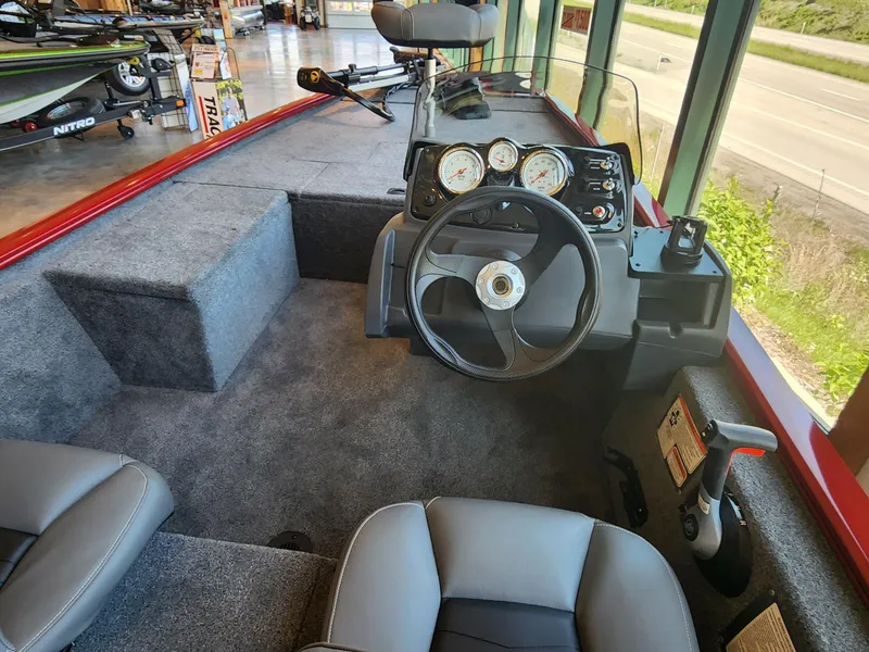 Slide: The Image of 2025 Tracker Pro 170 boat interior with steering wheel and dashboard controls. - 3