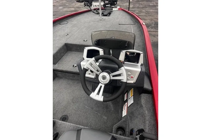Slide: The Image of 2025 Tracker Savage 215 boat interior with steering wheel and dashboard controls. - 86