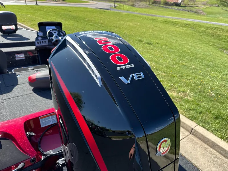 Slide: The Image of 2025 Nitro Z19 boat on trailer, parked outdoors with flags and scenic background. - 4