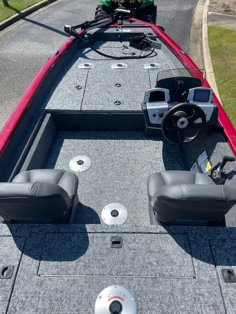 Slide: The Image of 2025 Tracker Pro Team 175 Crappie Edition boat interior with dual seats and steering console. - 2