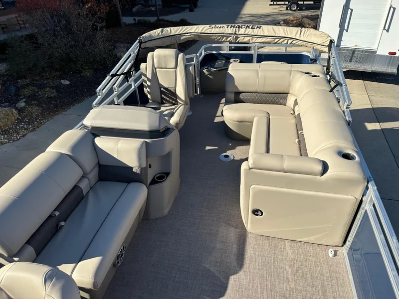 Slide: The Image of 2025 Sun Tracker Fishin' Barge 20 DLX with spacious seating and beige upholstery. - 5