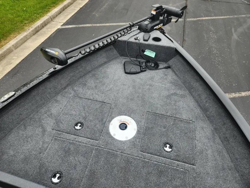 Slide: The Image of 2025 Tracker Pro Guide V-16 WT boat deck with trolling motor, carpeted surface, and storage compartments. - 3