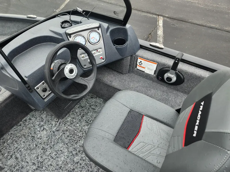 Slide: The Image of 2025 Tracker Pro Guide V-16 WT boat interior with steering wheel and dashboard controls. - 5