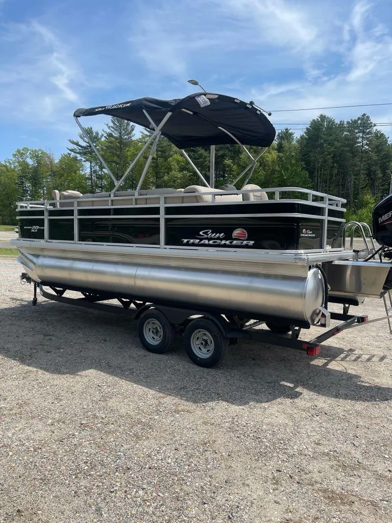 Slide: The Image of 2025 Sun Tracker SportFish 20 DLX pontoon boat on trailer, parked outdoors. - 4