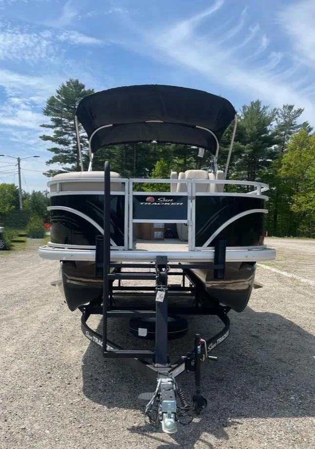 Slide: The Image of 2025 Sun Tracker SportFish 20 DLX pontoon boat on trailer, parked outdoors. - 5