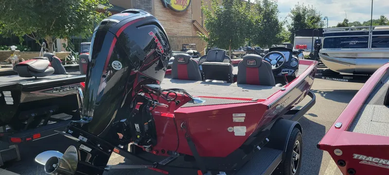 Slide: The Image of 2025 Ranger RT188P boat, red exterior, powerful outboard motor, parked outdoors. - 4