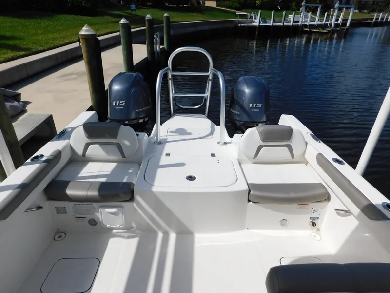 Slide: The Image of 2020 World Cat 230 DC boat with dual 175 engines docked by a calm waterfront. - 10